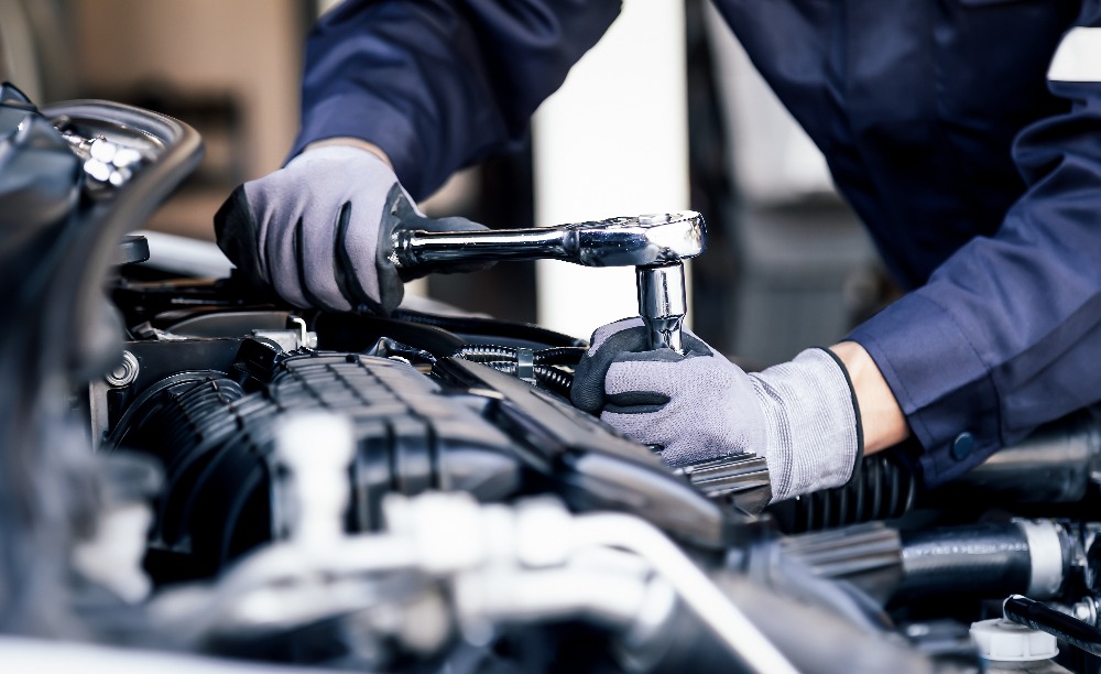 Professional mechanic working on the engine of the car in the garage car repair service the concept of checking the readiness of the car before leaving jpg